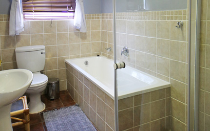 Family Self-Catering Suite suitable for families or couples sharing - offers full bathroom, styled elegantly.